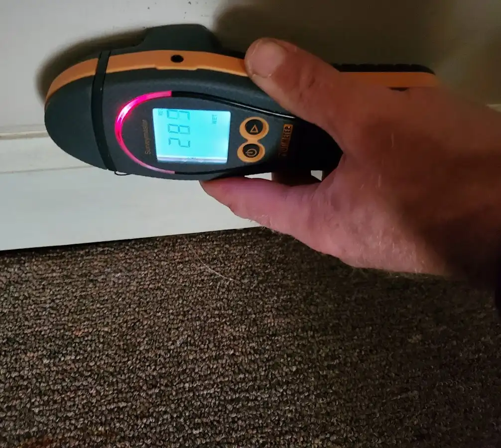 Moisture detection at baseboard during Storm Damage Restoration in Shirley